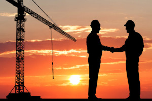 41073872 - silhouette of two architect at construction site shaking hand