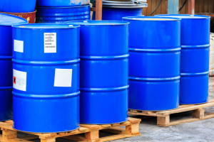 36247314 - big blue barrels standing on wooden pallets on a chemical plant