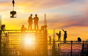 Silhouette of Engineer and worker on building site sunset in eve