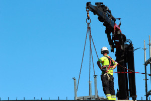 Rigger is helping the crane, keeping right balance and direction